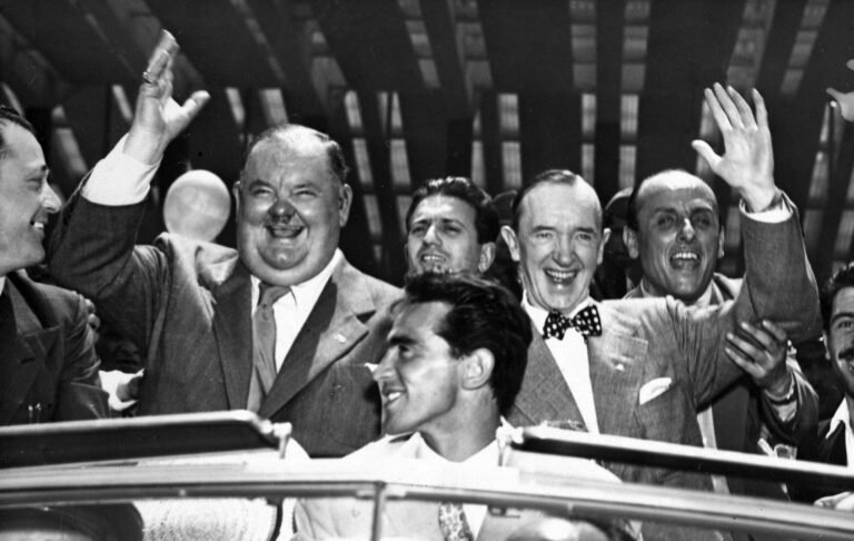 Laurel and Hardy waving to fans on arrival in Rome 1950